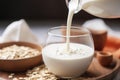 almond milk pouring into a bowl of oatmeal