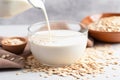 almond milk pouring into a bowl of oatmeal