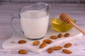 Almond milk in a transparent jug on a white background. Royalty Free Stock Photo