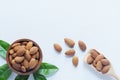 Almond nut in wood bowl and green leaf on wooden table background Royalty Free Stock Photo