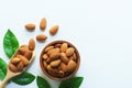 Almond nut in wood bowl and green leaf on wooden table background Royalty Free Stock Photo