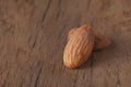 Almond nut in wood bowl on wooden table with green leaf background Royalty Free Stock Photo