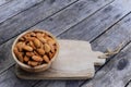 Almond nut in wooden bowl on wood table background, copy space Royalty Free Stock Photo