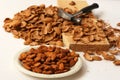 Almond nuts with hammer and nut shells on wooden board. Getting organic food concept Royalty Free Stock Photo