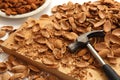 Almond nuts with hammer and nut shells on wooden board. Getting organic food concept Royalty Free Stock Photo