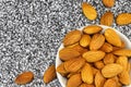 Almond nuts lie in a white glass bowl and on gray-white marble Royalty Free Stock Photo