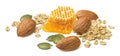 Almond nuts, rolled oats, green pumpkin seeds and honey isolated on white background Royalty Free Stock Photo