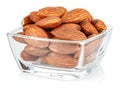 Almond nuts in a small transparent glass square bowl isolated on white background Royalty Free Stock Photo