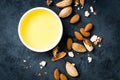 Almond oil in bowl and almond nuts. Almonds