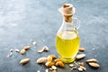 Almond oil in glass bottle and almond nuts. Almonds