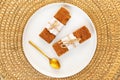 Almond and pecan nut financier cake with a golden spoon in a plate over a golden wire background, Flat lay, top view Royalty Free Stock Photo