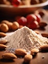 Almond powder and almonds on wooden table