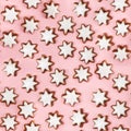 Almond stars biscuits with sugar icing on pink background.