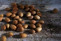 Almond unshelled, badam, handful forest fruit harvest on wood