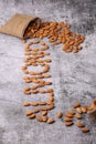 Almonds in bag isolated on grey background Royalty Free Stock Photo