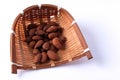 Almonds in bamboo basket on white background Royalty Free Stock Photo