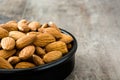 Almonds in black bowl on wood Royalty Free Stock Photo