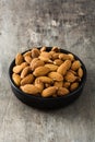 Almonds in black bowl on wood Royalty Free Stock Photo