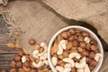 Almonds, cashew and hazelnuts in ceramic bowl on a rustic wooden Royalty Free Stock Photo