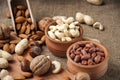 Almonds, cashew and hazelnuts in wooden bowls on wooden and burlap,nuts