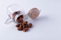 Almonds in glass bottles on a white background Royalty Free Stock Photo