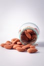 Almonds in glass bottles on a white background Royalty Free Stock Photo