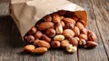 Almonds, hazelnuts, and walnuts spilling from a paper bag Royalty Free Stock Photo