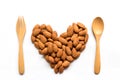 Almonds heart shape pattern with wooden fork and spoon. Royalty Free Stock Photo