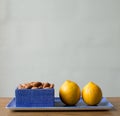 Almonds and lemons on blue dish