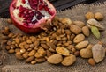Almonds in a mortar and pomegranate fruit. Royalty Free Stock Photo