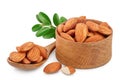 Almonds nuts with leaves in wooden bowl isolated on white background with clipping path and full depth of field. Royalty Free Stock Photo