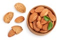 Almonds nuts with leaves in wooden bowl isolated on white background with clipping path and full depth of field. Top Royalty Free Stock Photo