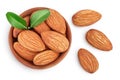 Almonds nuts with leaves in wooden bowl isolated on white background with clipping path and full depth of field. Top Royalty Free Stock Photo