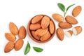 Almonds nuts with leaves in wooden bowl isolated on white background with clipping path and full depth of field. Top Royalty Free Stock Photo