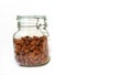 Almonds are packed in glass bottles on a white background. Royalty Free Stock Photo