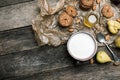 Almonds pears Cookies and milk on wooden table