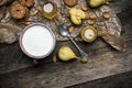 Almonds pears Cookies and milk on wooden table