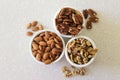 Almonds, Pecans, And Walnuts in Containers on Kitchen Countertop, Centered