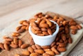 Almonds seed on in porcelain bolw on wooden table Royalty Free Stock Photo