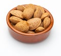 Almonds with shell in clay bowl. Royalty Free Stock Photo