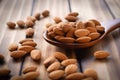 almonds in spoon wood on dark table background