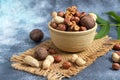 Almonds, walnuts, hazelnuts and peanuts, mix of nuts. Contains beneficial vitamins and minerals. On a gray background