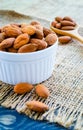 Almonds in white bowl on hemp Royalty Free Stock Photo