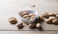 Almonds in white shell on wooden table