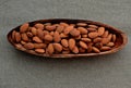 Almonds in a wooden bowl  on canvas napkin background Royalty Free Stock Photo