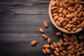 Almonds in wooden bowl on dark wood table. Almond concept with copyspace.topview Royalty Free Stock Photo