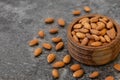 almonds in a wooden bowl on a gray background