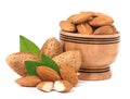 Almonds in a wooden bowl with leaves isolated on white background Royalty Free Stock Photo