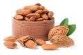 Almonds in a wooden bowl with leaves isolated on white background Royalty Free Stock Photo