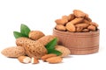 Almonds in a wooden bowl with leaves isolated on white background Royalty Free Stock Photo